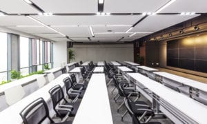 Modern lecture hall with video screens.